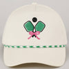 Beige cap with pickleball-themed design featuring green rackets, pink bow, and black ball 