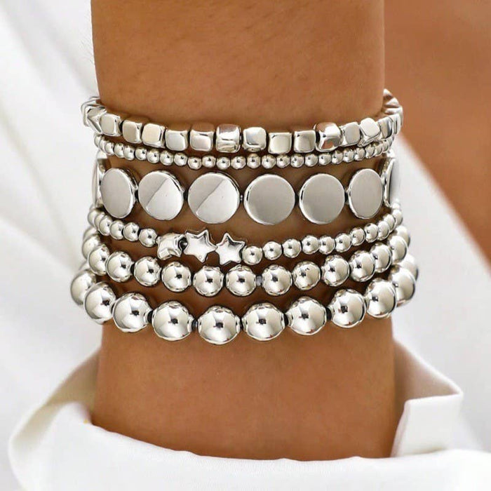 Stack of silver beaded bracelets 