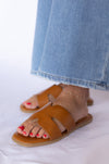 Brown sandals worn with blue jeans 