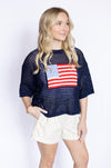 Woman wearing a navy blue top with an American flag design 