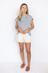 Woman wearing a gray top and white shorts