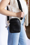 Person wearing a black crossbody bag 