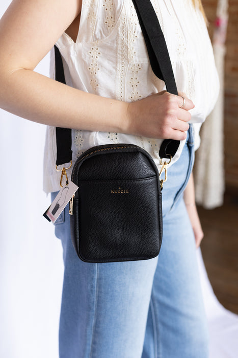 Person wearing a black crossbody bag 