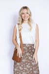 Woman holding a brown leather bag 