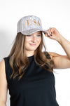 Woman wearing a cap with 'USA' text 