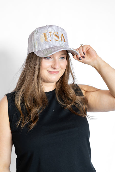Woman wearing a cap with 'USA' text 