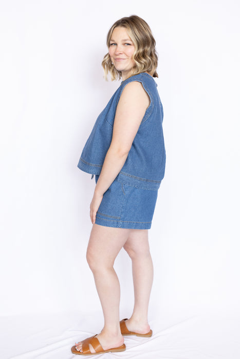 Woman wearing a blue denim top and shorts