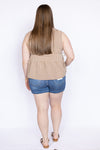 Woman wearing a sleeveless checkered top and denim shorts 