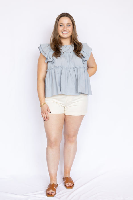 white high waisted shorts with light blue blouse and tan sandals