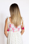 Woman wearing a floral dress with tassel details 