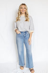 Woman wearing a striped shirt and jeans 