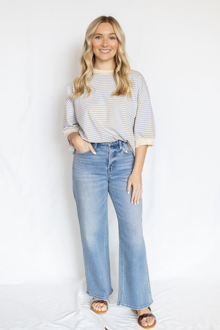 Woman wearing a striped shirt and jeans 