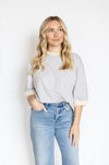 Woman wearing a striped shirt and jeans 