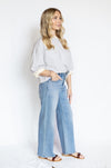 Woman wearing a striped shirt and wide-leg jeans 