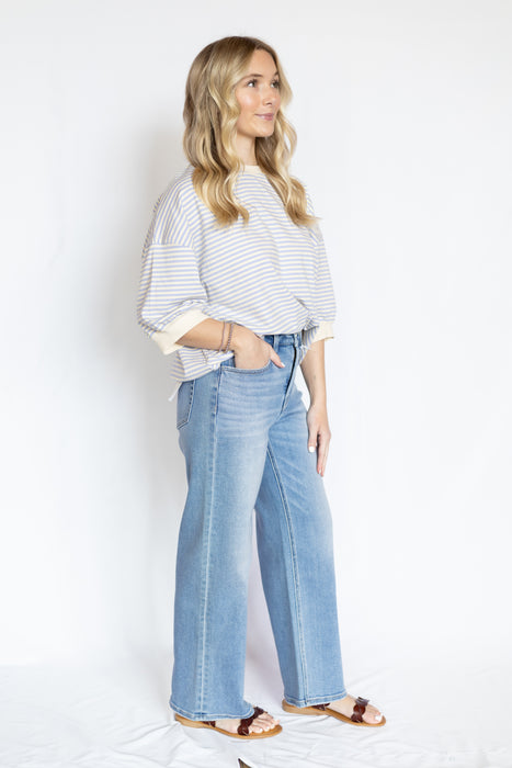 Woman wearing a striped shirt and wide-leg jeans 