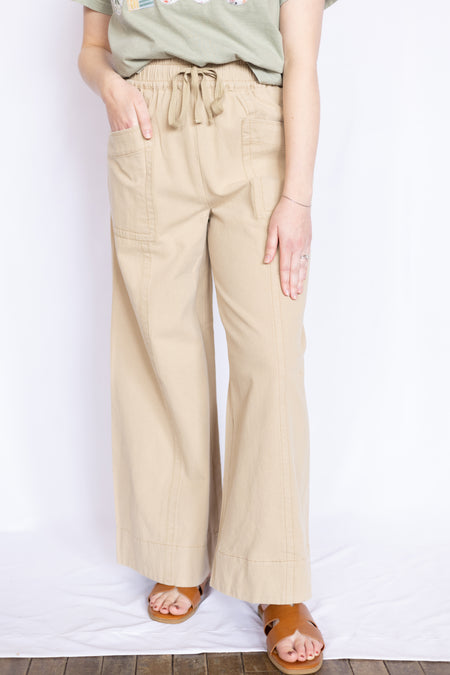 Person wearing beige wide-leg pants 