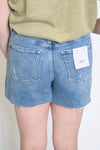 Person wearing blue denim shorts 