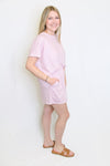 Woman wearing a light pink outfit 