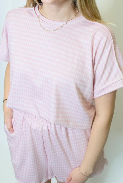 Person wearing a pink checkered outfit 