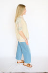 yellow floral and stripe top with blue jeans