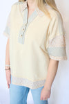 yellow floral and stripe top with three buttons