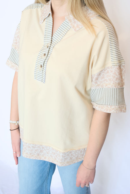 yellow floral and stripe top with three buttons