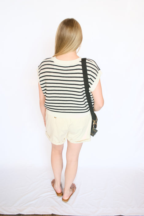 Black sleeveless striped sweater tank with white shorts and brown sandals