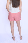 Person wearing red checkered shorts 
