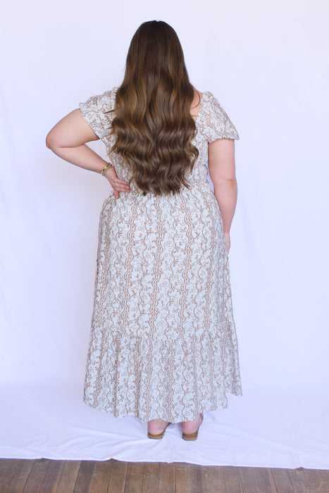 Woman wearing a brown floral dress 