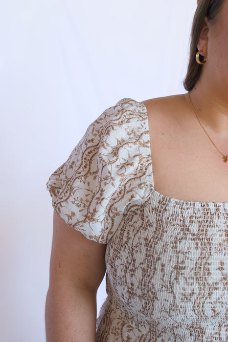 Person wearing a patterned dress 