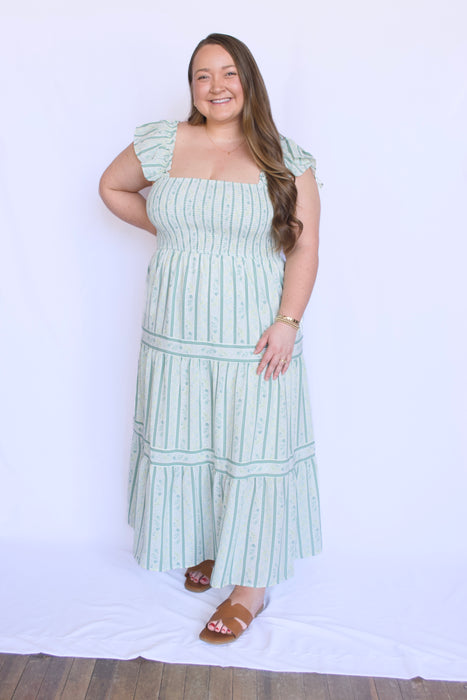 Woman wearing a green and white striped dress 