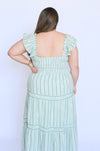 Woman wearing a light green dress with vertical stripes 