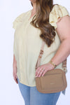 Woman holding a brown handbag 