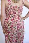 Woman wearing a floral dress with pink and beige pattern 
