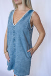 Woman wearing a blue denim dress 