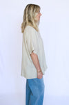 Woman wearing a beige blouse and blue pants 