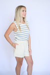 Woman wearing a striped shirt and shorts 