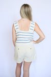 Person wearing a striped sleeveless top and shorts 