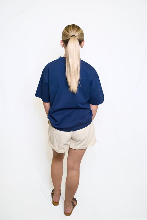Person wearing a blue shirt and white shorts 