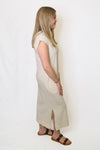 Woman wearing a beige sleeveless dress 
