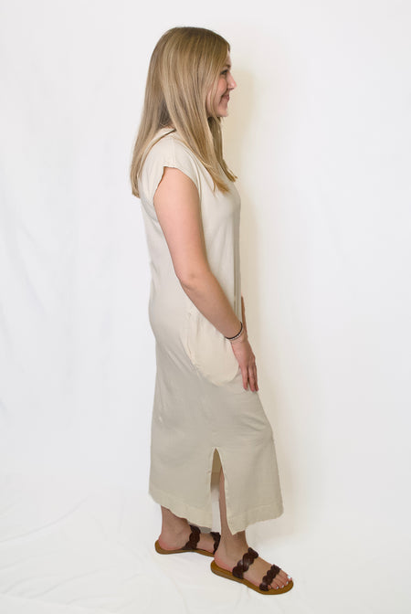 Woman wearing a beige sleeveless dress 