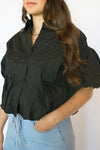 Person wearing a black shirt and light blue jeans 