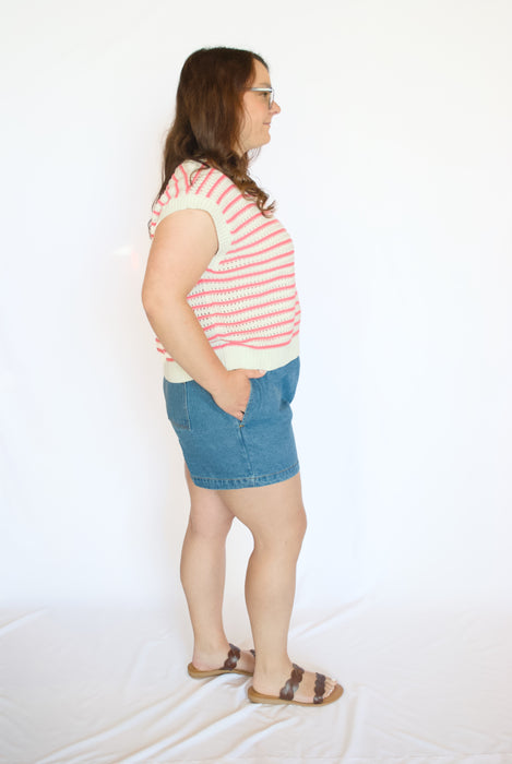 Woman wearing a striped shirt and denim shorts