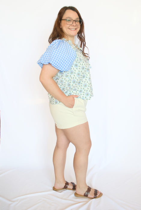 Woman wearing a colorful top and light shorts 