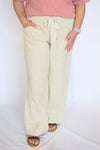 Person wearing light-colored striped pants and a pink top 