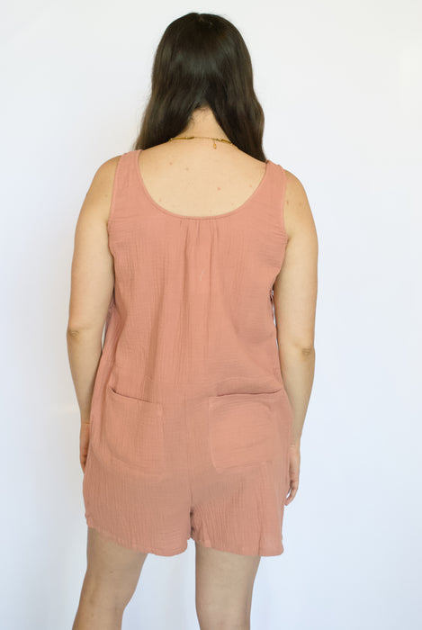 Person wearing a pink sleeveless romper 
