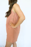 Woman wearing a pink romper with buttons 