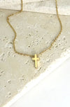 Gold necklace with a small cross pendant 