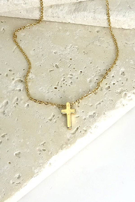 Gold necklace with a small cross pendant 