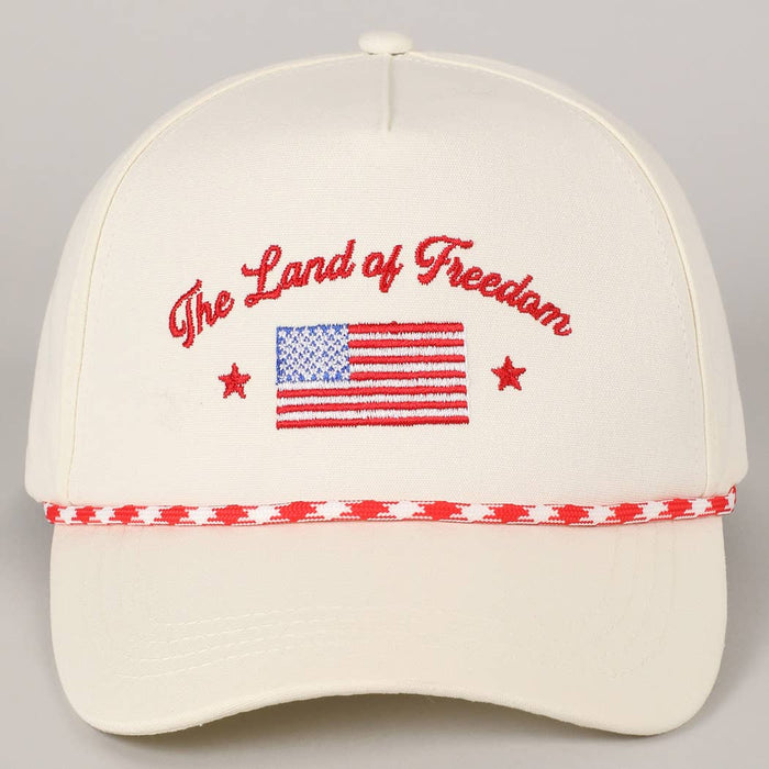 White cap with 'The Land of Freedom' text and American flag design 